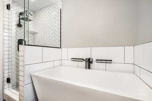 Bathroom with a freestanding bath and a stall shower