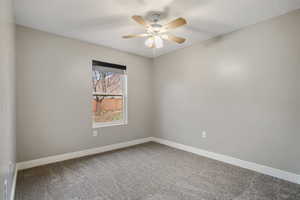 Spare room with carpet floors and a ceiling fan