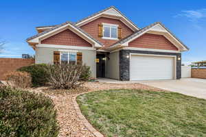 Craftsman-style home with concrete driveway, an attached garage, stucco siding, and stone siding