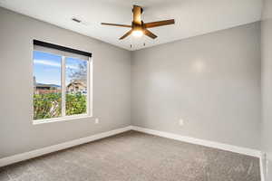 Unfurnished room with carpet flooring and a ceiling fan