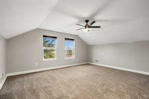 Bonus room with light carpet, ceiling fan, and a textured ceiling