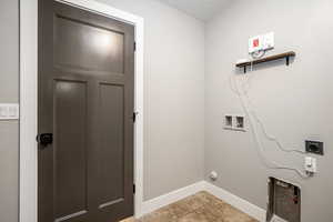 Laundry room featuring washer hookup, hookup for an electric dryer, and light tile patterned floors