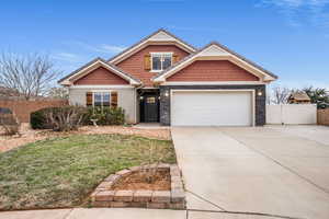 Craftsman-style home featuring concrete driveway, a garage, and stone siding