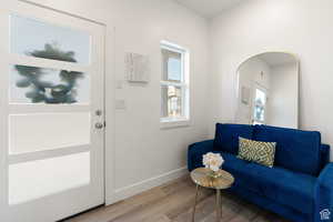 Foyer with baseboards and light wood finished floors