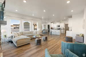 Living area featuring light wood finished floors and recessed lighting