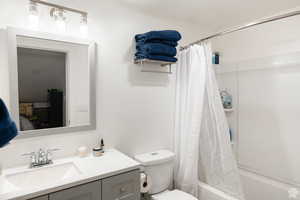 Full bathroom featuring shower / bathtub combination with curtain and vanity