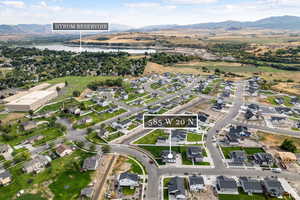 Aerial view of property's location featuring nearby suburban area and a water and mountain view