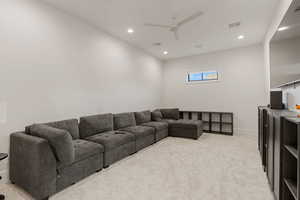 Living area with light carpet, recessed lighting, and ceiling fan