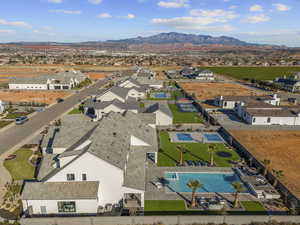 Aerial view of residential area with a pool area and mountains