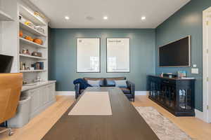 Home office with recessed lighting and light wood-type flooring