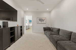Living room with light carpet, recessed lighting, and ceiling fan