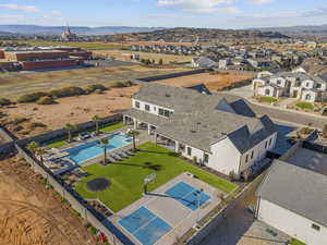 Aerial perspective of suburban area with a pool area and a mountain backdrop