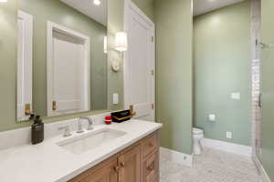 Bathroom with vanity, a stall shower, light tile patterned floors, and recessed lighting