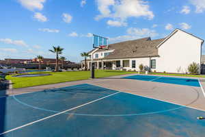 View of sport court featuring community basketball court, a patio, and a yard