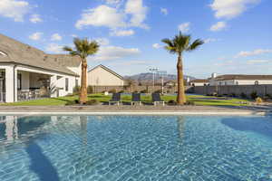 View of swimming pool with patio surround and area for grilling