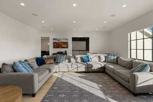 Living room with recessed lighting and light wood-style floors