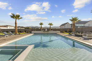 Integrated pool / spa featuring a patio area, an outdoor lounge area, a fenced backyard, a mountain view, and a residential view