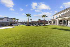 View of yard with a patio area and an outdoor pool