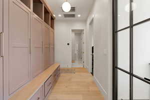 Mudroom with recessed lighting and light wood finished floors