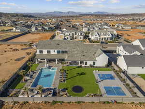 Aerial perspective of suburban area with mountains and a pool