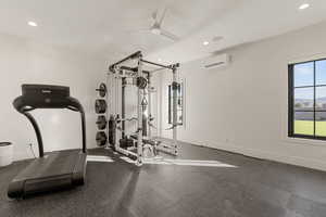 Exercise room featuring ceiling fan, recessed lighting, and a mini split for heating / cooling