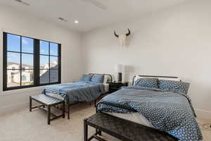 Bedroom with light colored carpet, a ceiling fan, and recessed lighting