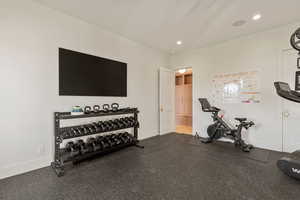 Workout room with rubber floors and recessed lighting