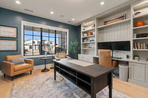 Office area featuring light wood-type flooring and recessed lighting