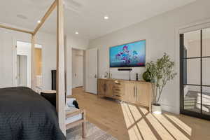 Bedroom with hardwood / wood-style flooring, a ceiling fan, recessed lighting, access to exterior, and ensuite bathroom