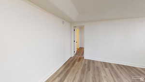 Unfurnished room featuring baseboards and wood finished floors
