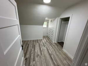Bonus room with light wood finished floors and baseboards