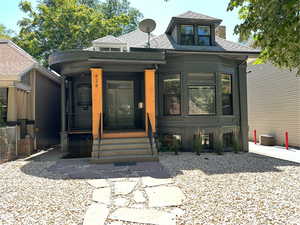 View of front of house featuring a porch and roof with shingles
