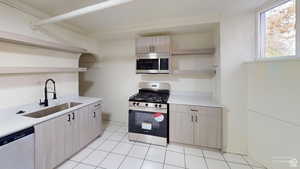 Kitchen with open shelves, light wood finish cabinets, stainless steel appliances, and light tile patterned floors