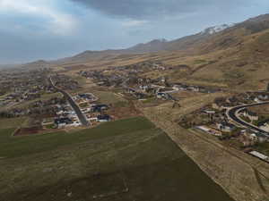 Aerial view of property's location with a mountainous background, nearby suburban area, and rural landscape