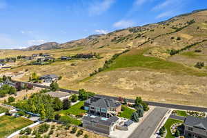 Aerial view of property's location featuring a mountainous background and nearby suburban area