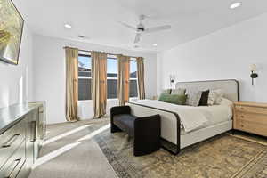 Carpeted bedroom featuring a ceiling fan and recessed lighting
