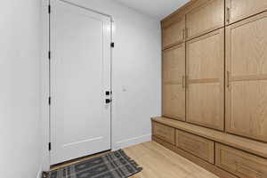 Mudroom featuring baseboards and light wood-style flooring