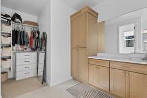 Walk in closet featuring light tile patterned floors