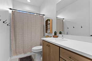 Full bath featuring vanity, a shower with curtain, and light tile patterned floors