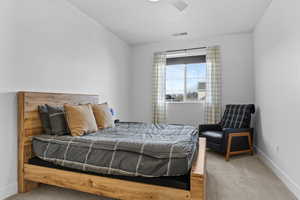 Carpeted bedroom with baseboards and ceiling fan