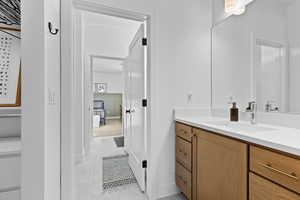 Bathroom featuring vanity and baseboards
