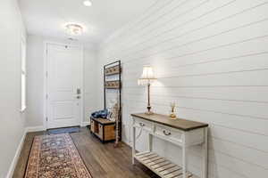 Foyer entrance featuring baseboards and dark wood finished floors