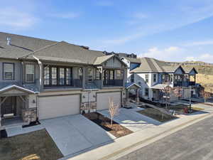 Craftsman inspired home with a balcony, concrete driveway, a garage, and a shingled roof