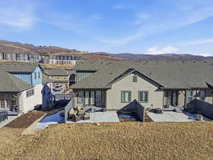 Rear view of property with a patio, a mountain view, a shingled roof, and outdoor lounge area
