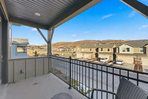 Balcony featuring a residential view and a mountain view