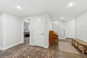 Foyer with dark wood-style flooring and recessed lighting