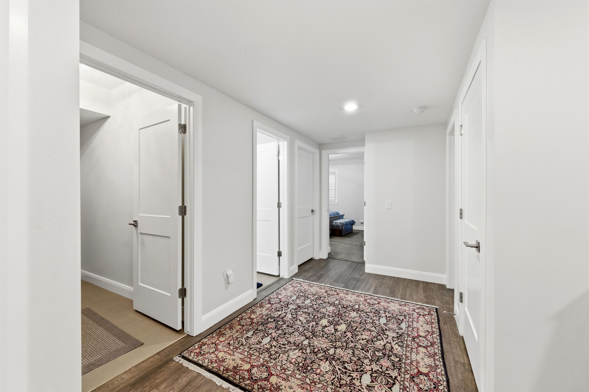 Corridor with dark wood finished floors and recessed lighting