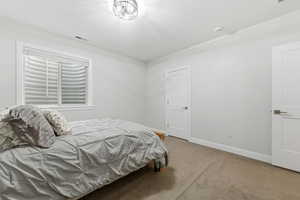 Bedroom with baseboards and carpet