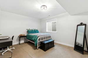 Bedroom featuring baseboards and carpet