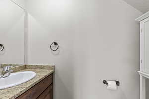 Half bath with vanity near kitchen